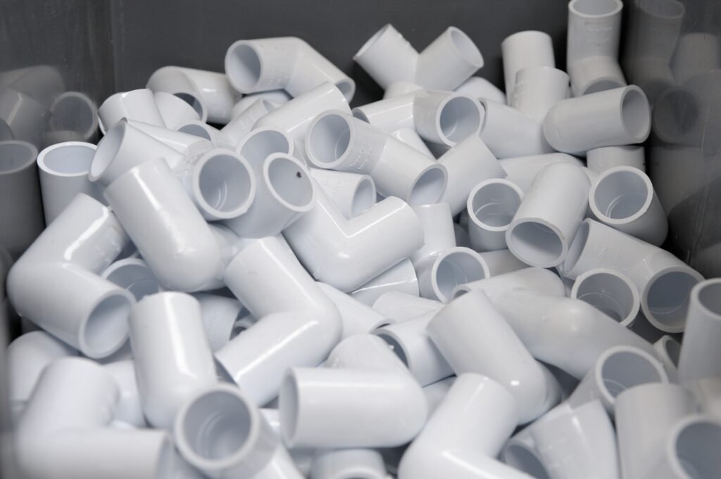 many-white-pvc-pipes-and-connectors-close-up