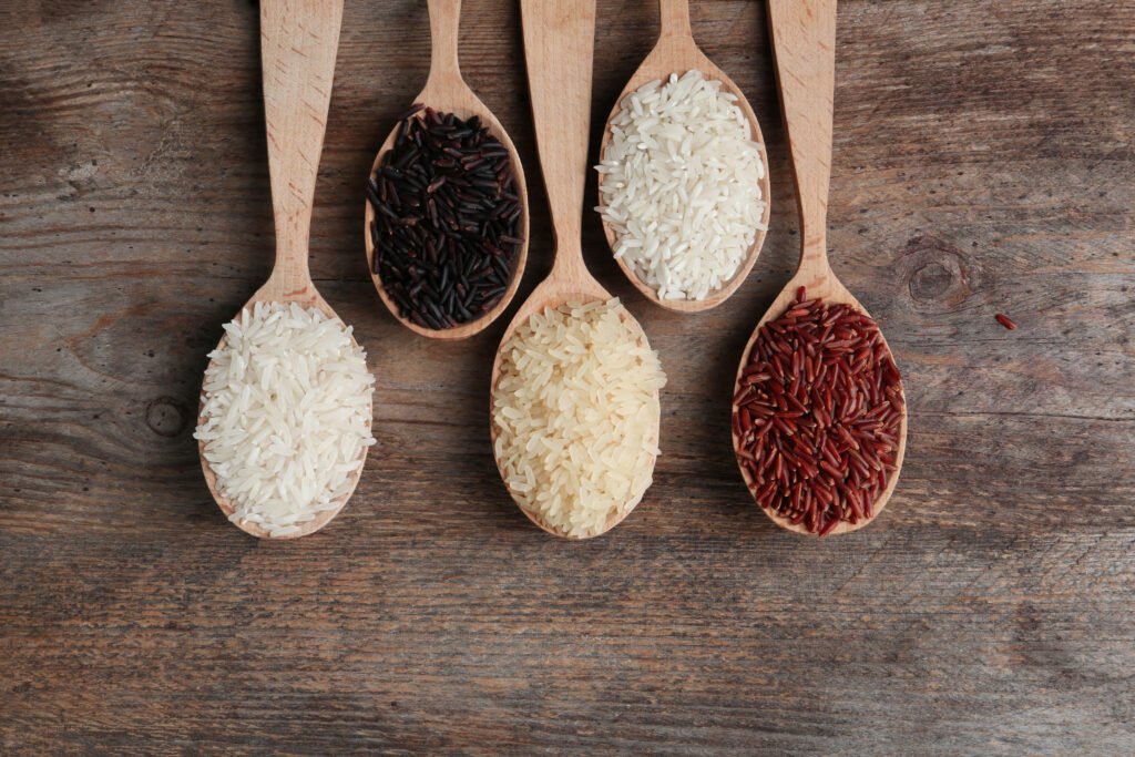 various-types-of-rice-on-wooden-spoons-scaled