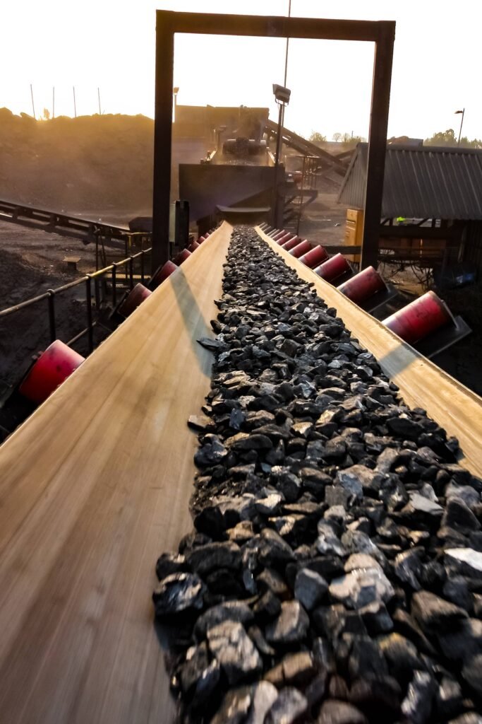 vertical-shot-of-coal-ore-on-a-conveyor-belt